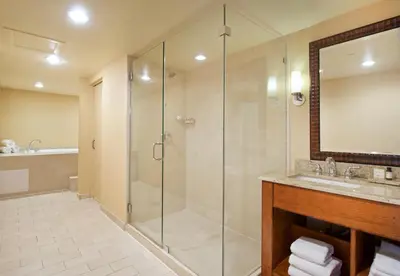 a bathroom with a shower and a sink and a mirror at Lake Arrowhead Resort & Spa in Lake Arrowhead