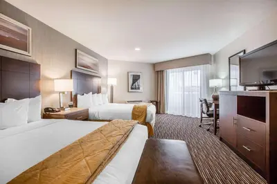 a hotel room with two beds and a television at Quality Inn & Suites Hermosa Beach in Hermosa Beach