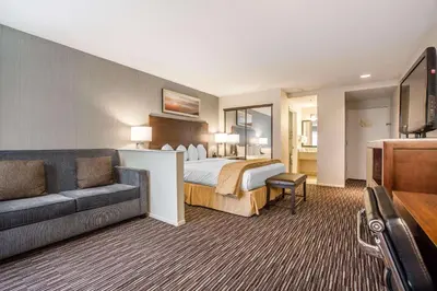 a hotel room with a bed and a couch at Quality Inn & Suites Hermosa Beach in Hermosa Beach