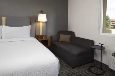 a hotel room with a bed and a chair at Four Points by Sheraton Los Angeles Westside in Los Angeles