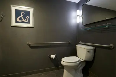 a bathroom with a toilet and a picture on the wall at Four Points by Sheraton Los Angeles Westside in Los Angeles
