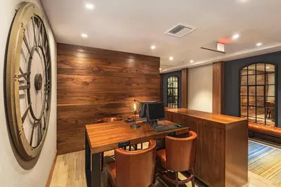 an office with a desk and a clock on the wall at Four Points by Sheraton Los Angeles Westside in Los Angeles