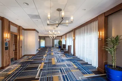 a hallway with a long row of chairs and a ceiling at Four Points by Sheraton Los Angeles Westside in Los Angeles