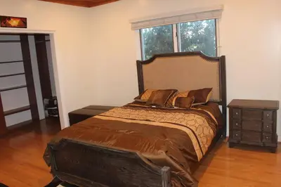 a bedroom with a large bed and a window at Luxurious 3 BD in Culver City with POOL &HOT SPA in Los Angeles