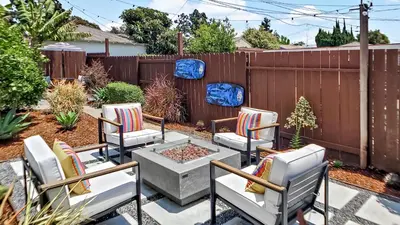 a patio with chairs and a fire pit in a backyard at Studio Mins to LAX , Venice Beach & Sony Studios CC B in Los Angeles