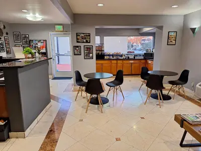 a restaurant with two tables and chairs in a room at Portofino Inn Burbank in Burbank