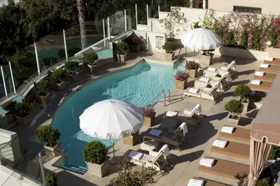 an overhead view of a pool with chairs and umbrellas at Sunset Tower Hotel in Los Angeles