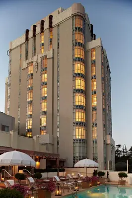 a large building with a pool in front of it at Sunset Tower Hotel in Los Angeles