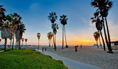 a group of people walking on a beach with palm trees at 2BD 2BTH Condo 10 Min Walk to Santa Monica Beach in Los Angeles