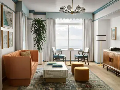 a living room with a couch and a table at The Georgian Hotel in Los Angeles