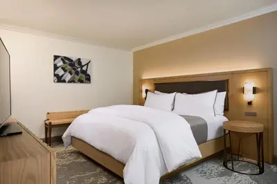 a bedroom with a large bed with white sheets at The Westin Los Angeles Airport in Los Angeles