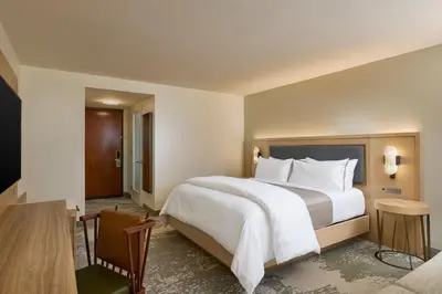 a hotel room with a large bed and a desk at The Westin Los Angeles Airport in Los Angeles