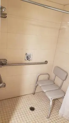 a chair in a bathroom with a towel at Royal Century Hotel at LAX in Inglewood