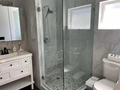 a bathroom with a shower with a glass door at Renovateed Two-Bedroom Apartment in Santa Monica in Los Angeles