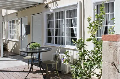 a patio with a table and chairs and a window at Charming Apartment in Santa Monica