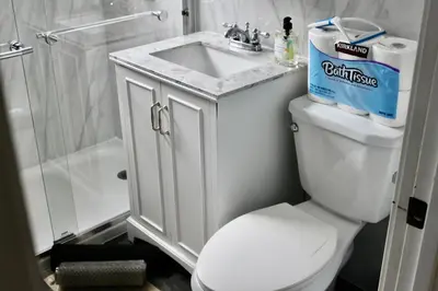 a bathroom with a white toilet and a sink at Charming Apartment in Santa Monica