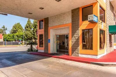 a building with an open door on a street at Rodeway Inn Artesia Cerritos in Artesia