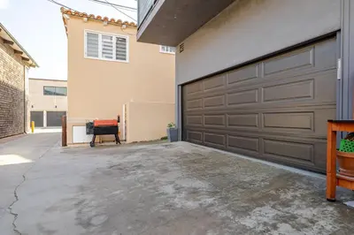 a garage with a large brown garage door at Oceanfront Oasis in Long Beach