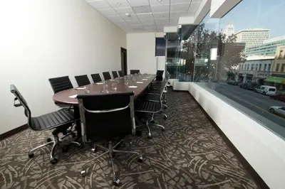 a conference room with a long table and chairs at Miyako Hotel Los Angeles in Los Angeles