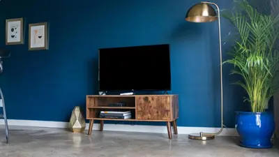 a living room with a tv on a wooden entertainment center at THE MIDNIGHT LOFT BY BOBOU DESIGN (KING SUITE) in Los Angeles