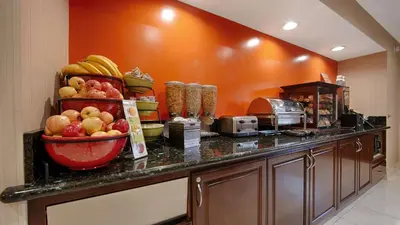 a kitchen counter with a bunch of fruit on it at Best Western Pasadena Inn in Pasadena