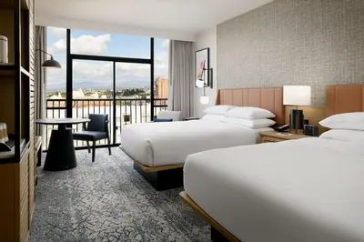 a hotel room with two beds and a balcony at Sheraton Park Hotel at the Anaheim Resort in Anaheim