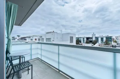 a balcony with a table and chairs on a roof at Shade Hotel Manhattan Beach in Manhattan Beach