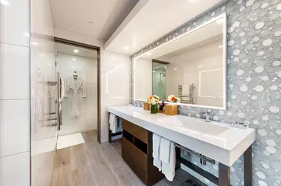 a bathroom with a sink and a mirror at Shade Hotel Manhattan Beach in Manhattan Beach