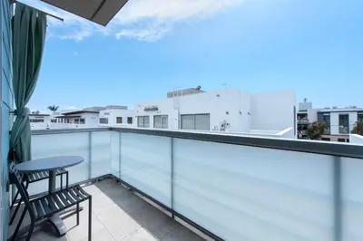 a balcony with a chair and a view of the city at Shade Hotel Manhattan Beach in Manhattan Beach