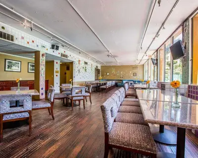 a waiting room with couches and tables and a tv at Quality Inn & Suites Montebello - Los Angeles in Montebello