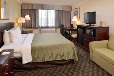 a hotel room with a bed and a flat screen tv at Quality Inn & Suites Montebello - Los Angeles in Montebello