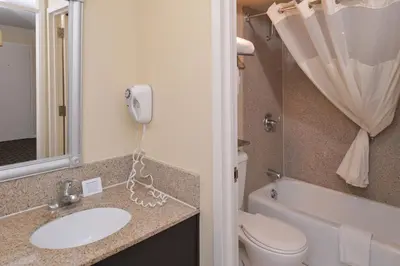 a bathroom with a sink and a toilet and a phone at Quality Inn & Suites Montebello - Los Angeles in Montebello