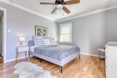 a bedroom with a bed and a ceiling fan at New Belmont Shore Retreat with free Parking Walk to Beaches in Long Beach