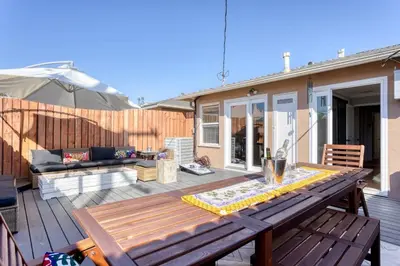 a patio with a wooden table and a couch at New Belmont Shore Retreat with free Parking Walk to Beaches in Long Beach