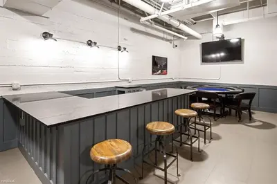 a bar with stools and a tv in a room at Fashion Loft 2 bedroom Downtown in Los Angeles