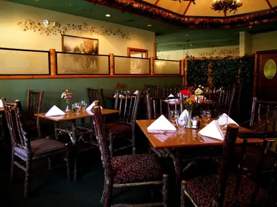 a restaurant with wooden tables and chairs with napkins at Holiday Inn Resort The Lodge at Big Bear Lake by IHG in Big Bear Lake