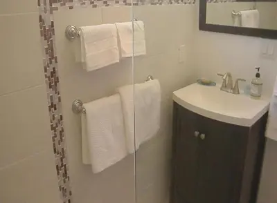 a bathroom with a shower and a sink and towels at Venice Beach Apartments Monthly rents in Los Angeles
