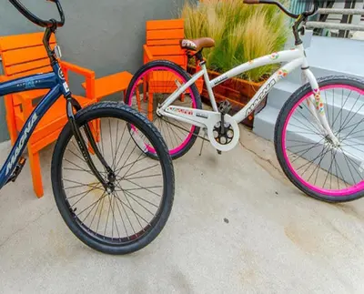 a bike is parked next to a bench at Venice Beach Apartments Monthly rents in Los Angeles