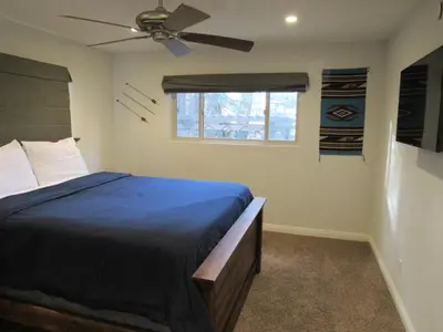 a bedroom with a bed and a ceiling fan at Monticello in Big Bear Lake
