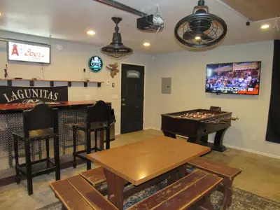 a room with a ping pong table and a bar at Monticello in Big Bear Lake