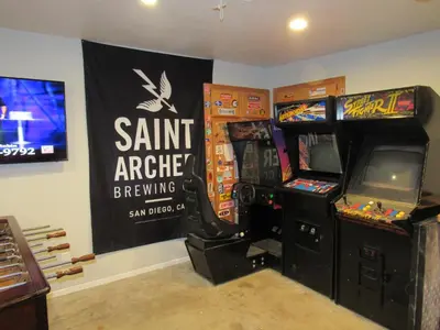 a gaming room with two arcade games and a sign at Monticello in Big Bear Lake