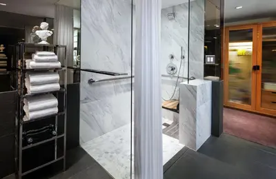 a bathroom with a shower and a glass door at SLS Hotel, a Luxury Collection Hotel, Beverly Hills in Los Angeles