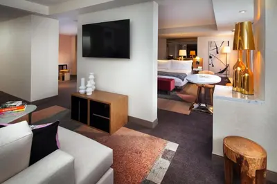 a living room with a couch and a room with a bed at SLS Hotel, a Luxury Collection Hotel, Beverly Hills in Los Angeles