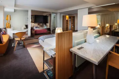 a hotel room with a bed and a living room at SLS Hotel, a Luxury Collection Hotel, Beverly Hills in Los Angeles