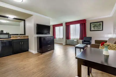 a living room with a couch and a table at Best Western Plus South Bay Hotel in Lawndale