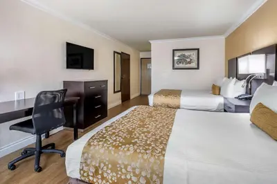 a hotel room with two beds and a desk at Best Western Plus South Bay Hotel in Lawndale