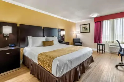 a hotel room with a bed and a desk at Best Western Plus South Bay Hotel in Lawndale