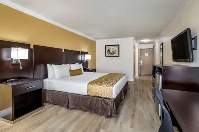 a hotel room with a bed and a flat screen tv at Best Western Plus South Bay Hotel in Lawndale