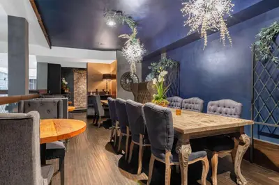 a dining room with a wooden table and chairs at The O Hotel, Trademark Collection by Wyndham in Los Angeles
