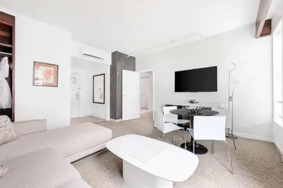 a white living room with a couch and a table at The O Hotel, Trademark Collection by Wyndham in Los Angeles